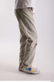 Bryton  1 casual dressed flexing grey jeans leg side…